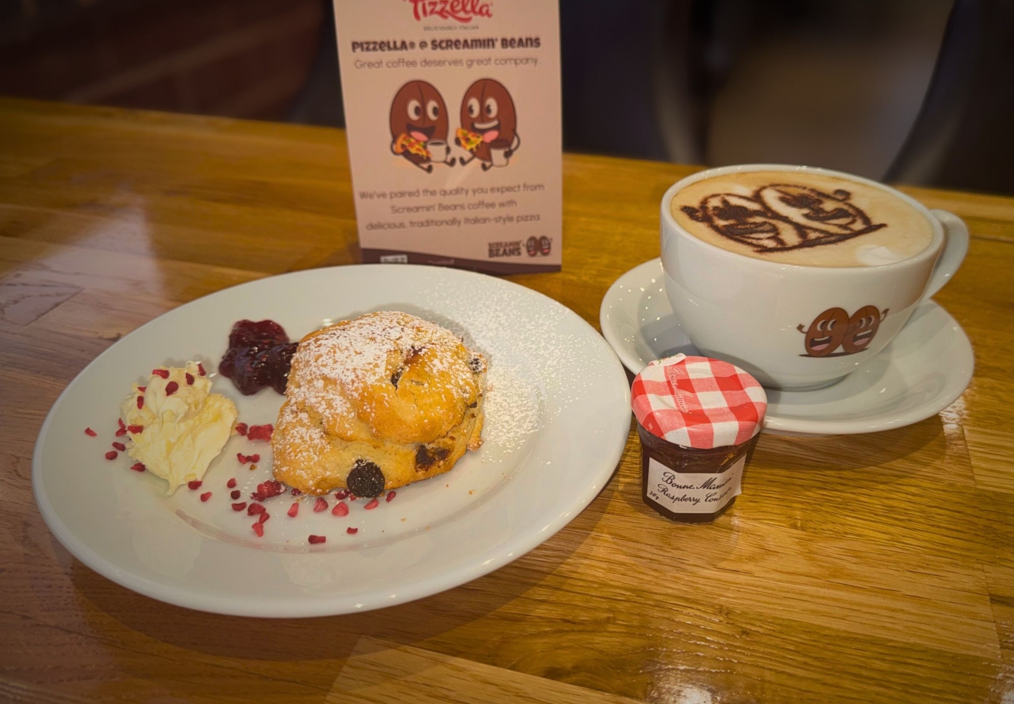Scone served with cream, jam and a branded Screamin' Beans coffee